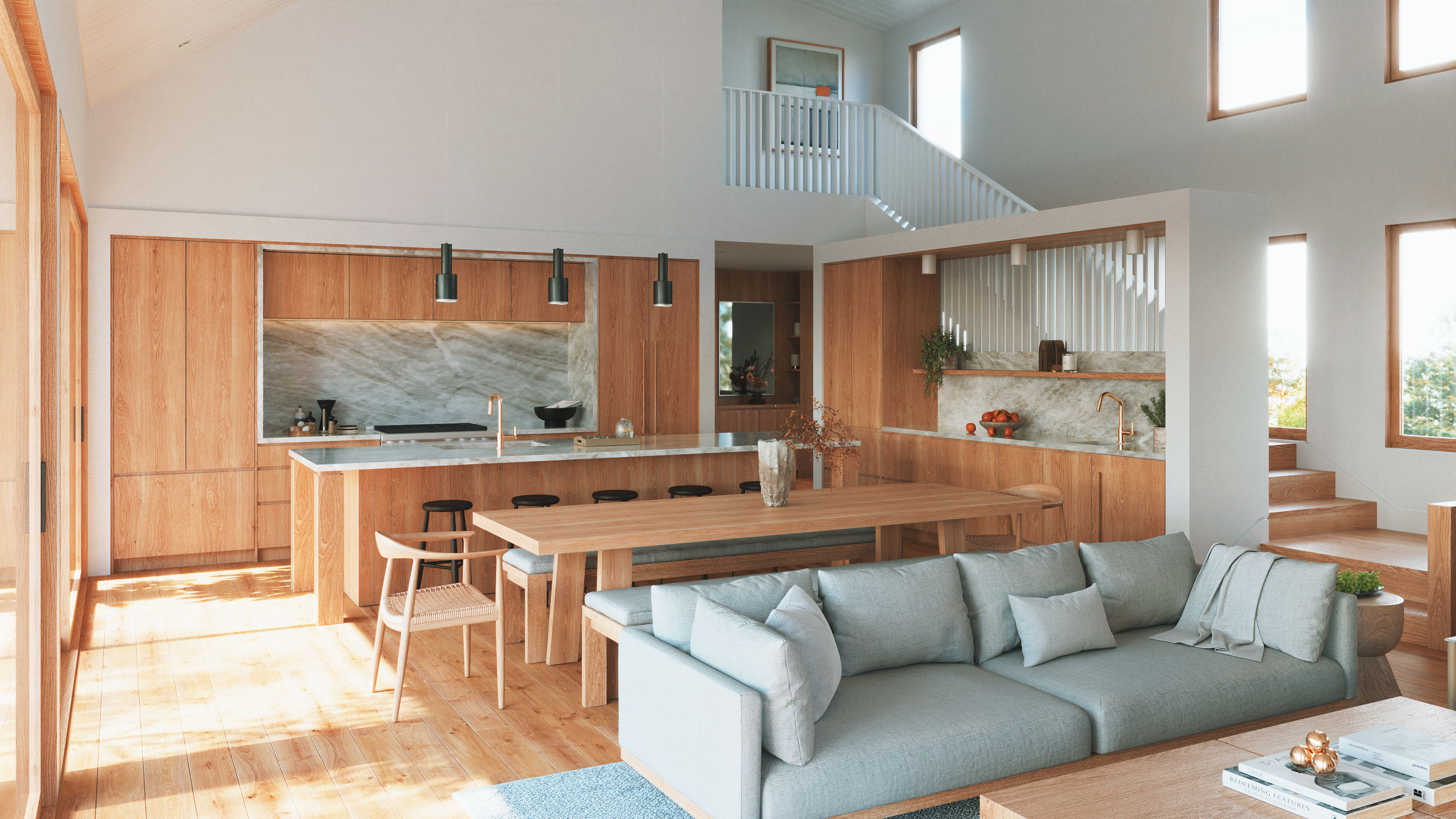 Modern open-concept kitchen and living space featuring warm wood cabinetry, a large marble-topped island, an adjoining wooden dining table with benches, and a light blue sofa in the foreground.
