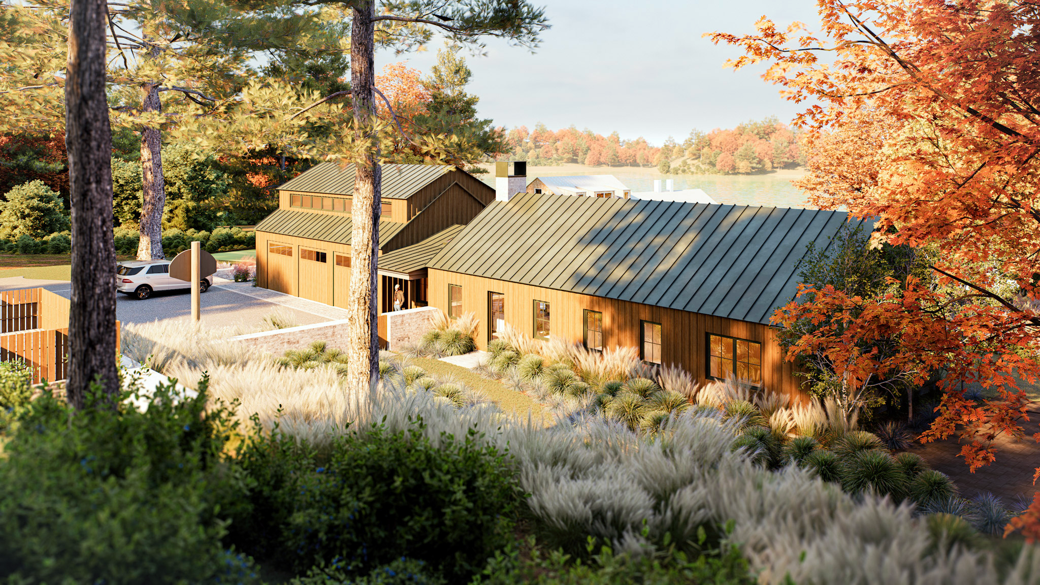 Rustic modern home featuring warm vertical wood siding, a dark standing-seam metal roof, and layered ornamental grasses along a sloped walkway against an autumn backdrop