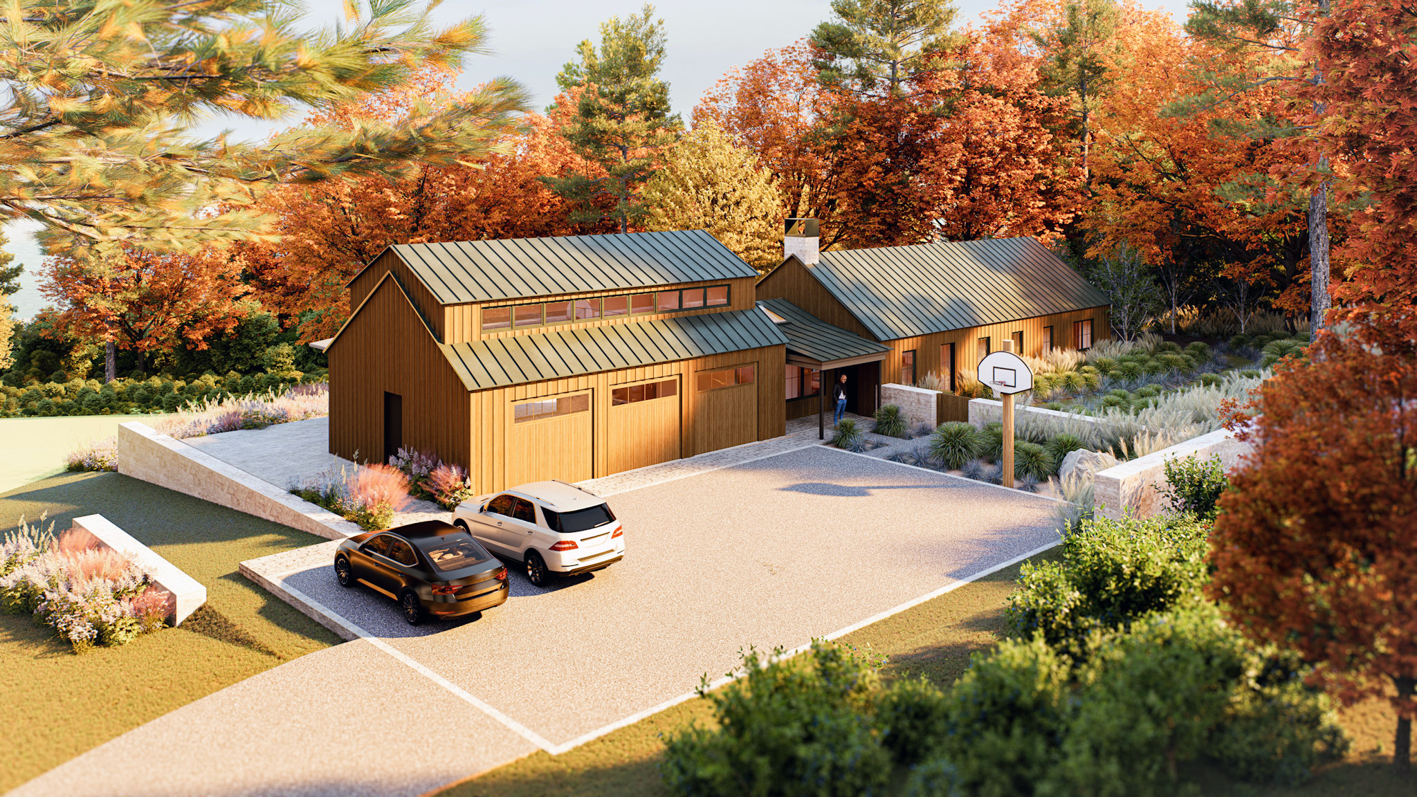 Rustic modern property featuring a warm wood barn-style multi-car garage with clerestory windows, an adjacent main home with a matching dark metal roof, a gravel driveway with parked vehicles, a basketball hoop, and vibrant autumn foliage surrounding the landscape