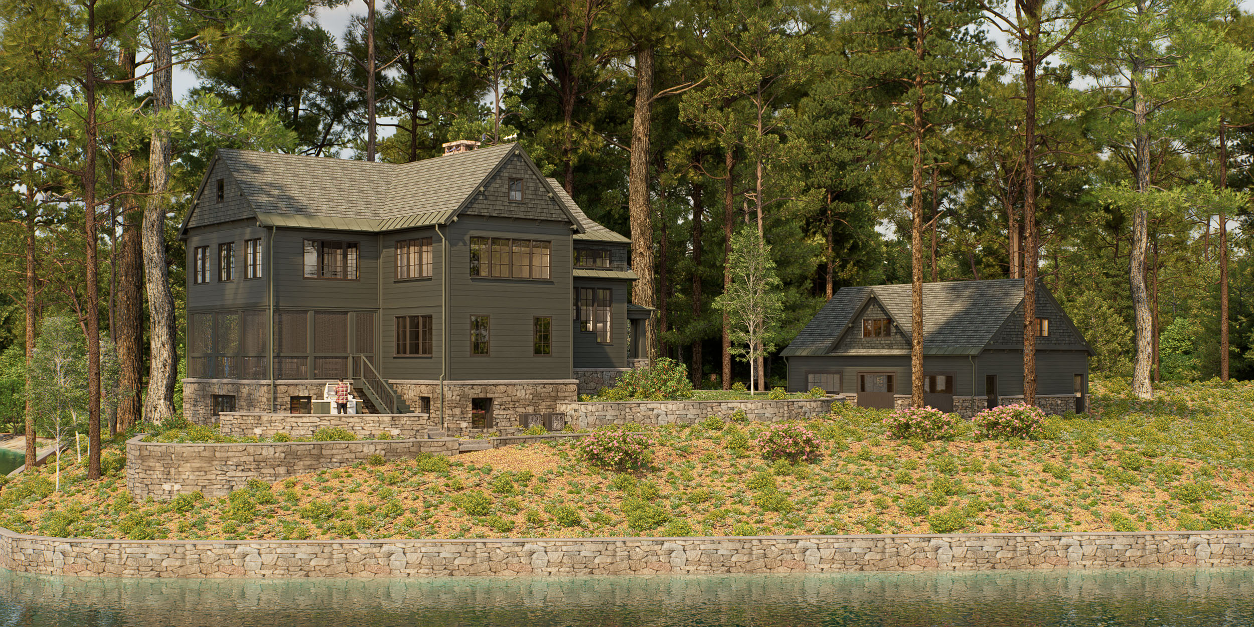 Craftsman style lakeside home featuring dark olive siding, stone foundation walls, and a detached garage set against a wooded shoreline along the water